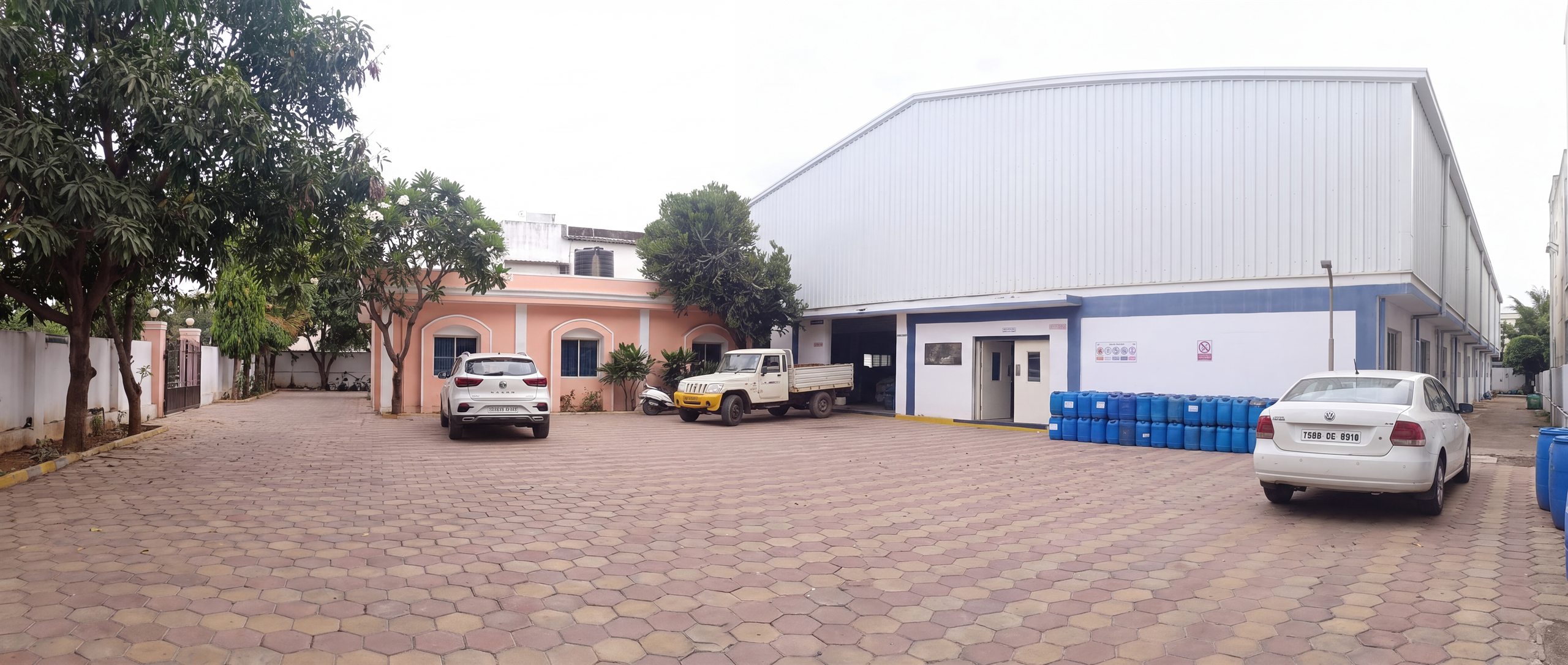 Wide view of the MetalGuard works — manufacturing shed, office block and loading yard, IDA Nacharam, Hyderabad