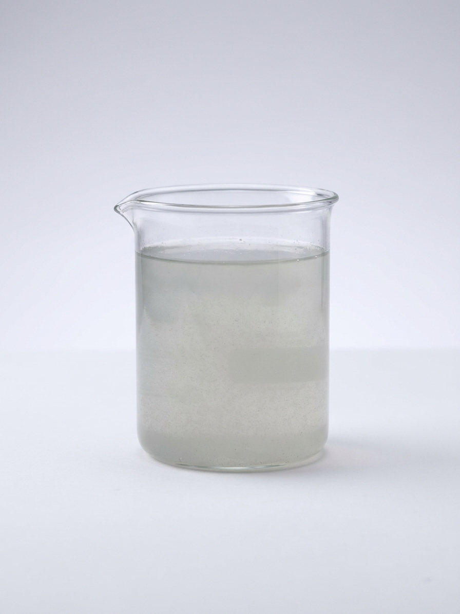 Cloudy phosphating bath liquid in a glass beaker